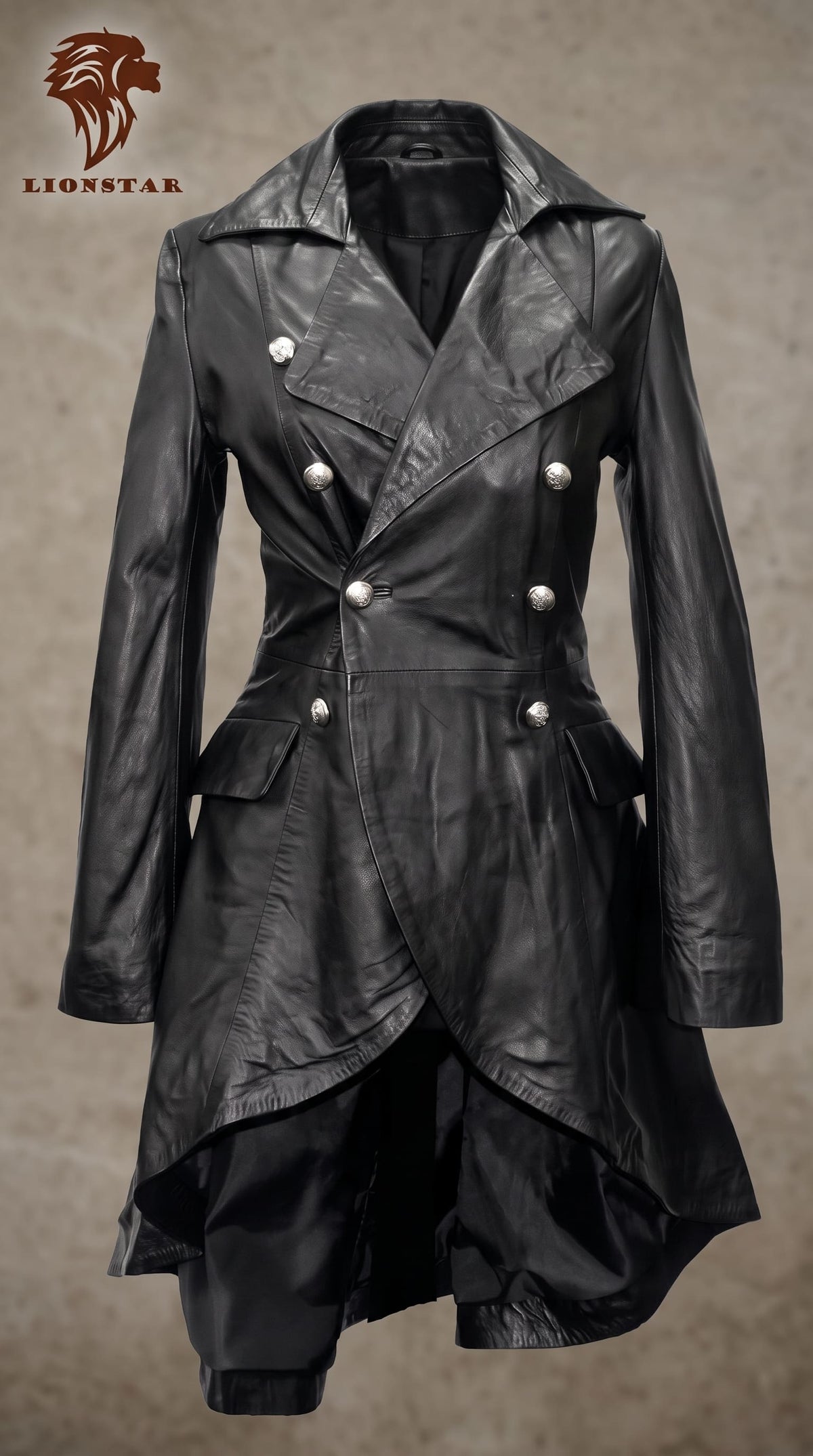 A black real sheep leather double-breasted trench coat with silver-tone buttons, displayed on a mannequin against a textured brown background. The Lionstar brand logo is visible in the top left corner.